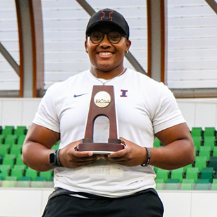 Abria Smith holding her NCAA trophy