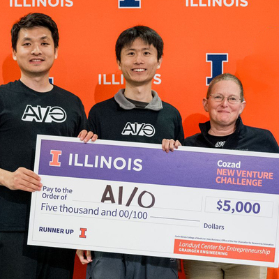 Duo Wang, Kyrien Liang, and Jen Whiting with their ceremonial check from the cozad new venture challenge