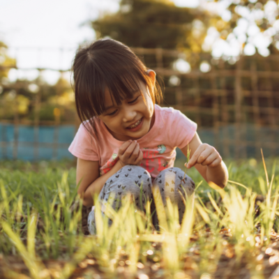 child playing with a plant