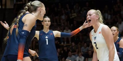 two Illini volleyball players scream in each other's faces in celebration