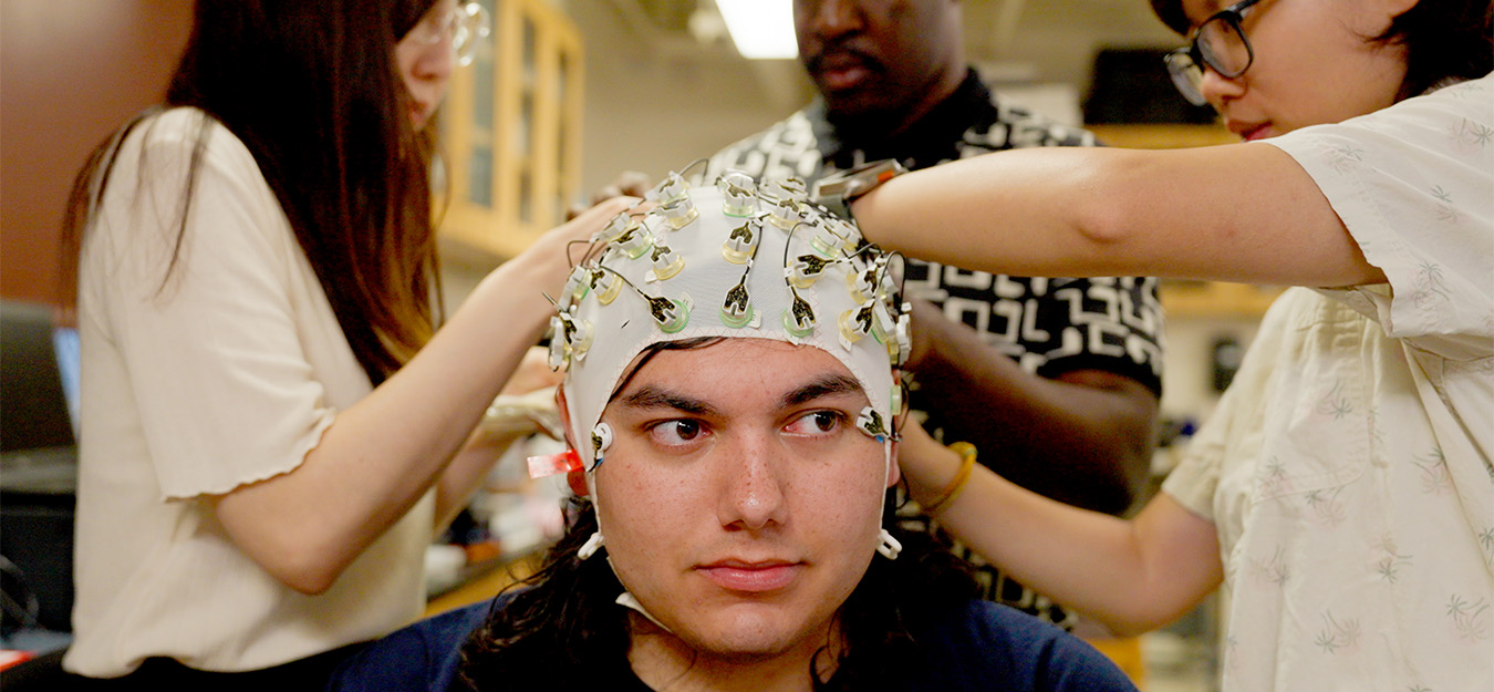 As part of a study of stress and the brain, researchers monitor electrical signals on a participant’s scalp using a swim cap studded with electrodes. Photo by Virgil Ward