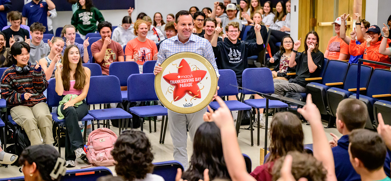 Marching Illini director Barry Houser announces to band members that they will perform in the 100th Macy’s Thanksgiving Day Parade in 2026. The band assembled at the Harding Band Building to hear the historic news. This will be Marching Illini’s second appearance in the parade, with the first being in 2015. Photo by Fred Zwicky