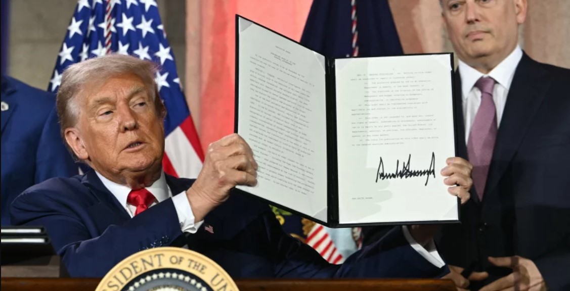 Trump displays an executive order on artificial intelligence he signed in Washington, DC, on July 23, 2025.  Andrew Caballero-Reynolds/AFP via Getty Images