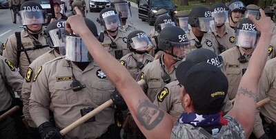Police confront demonstrators during a protest outside an immigration processing and detention facility on Oct. 11 in Broadview, Ill. Photographer: Scott Olson/Getty Images