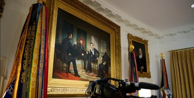 A painting of President Abraham Lincoln is visible on the wall during a Cabinet meeting at the White House in July. Andrew Harnik/Getty