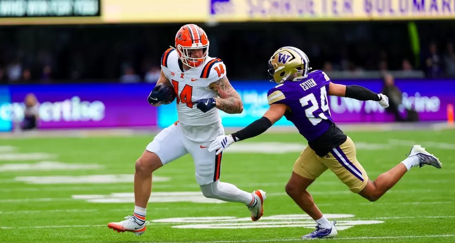 tight end Cole Rusk prepares to shove a Washington defender as he runs with the ball