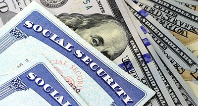 stock image of social security cards and dollars
