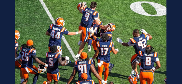 Illini players celebrate on the field after the winning field goal kick