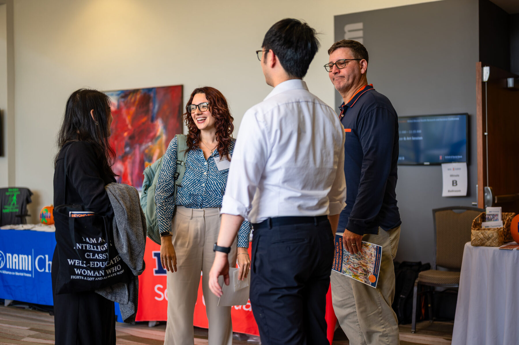 Photo depicts three individuals talking during the October 2025 Beyond Borders conference.