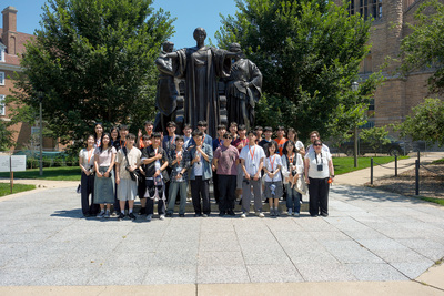 Twenty-four students from South Korea’s Chungnam National University, their advisor, and two Global Education and Training staff members, pose for a group photo in front of the University of Illinois Urbana-Champaign's Alma statue on July 17, 2026.