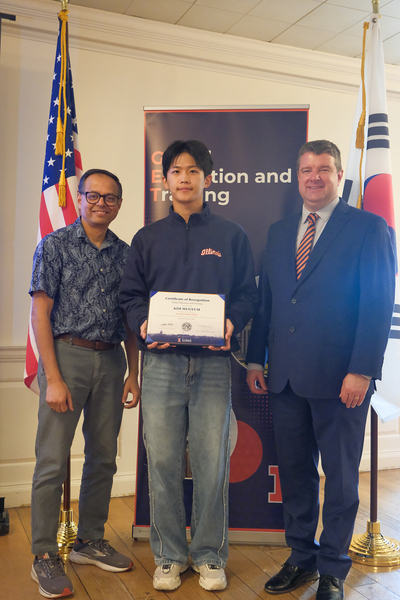 Mugyum Kim (center), a fourth-year undergraduate at Chungnam National University, holds up a certificate and poses for a photo with Romit Choudhury (left), professor in The Grainger College of Engineering; and GET Director Matt Rosenstein (right) following the recognition ceremony for the AI and Generative Models: From Algorithms to Applications research program on August 7, 2026.