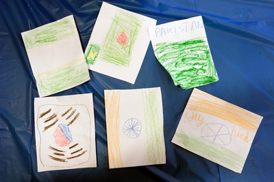 The photo depicts drawings of country flags like India and Korea that were drawn and colored in by children attending the International Families Celebration event on April 24, 2026.