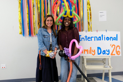 (From left to right) Hannah King, the children's program director at Orchard Downs, and Ezinne Okey, international training and programming specialist, pose for a photo during the April 24 International Families Celebration inside the Orchard Downs Community Center.