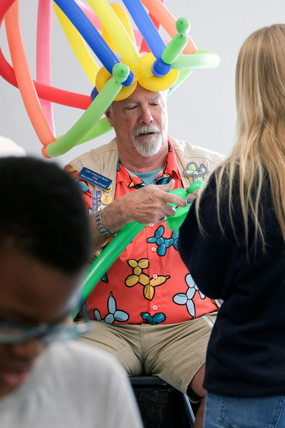 Doug Smith from&nbsp;The Unique Twist makes a balloon animal during the April 24 International Families Celebration inside the Orchard Downs Community Center.
