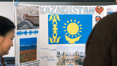 A poster depicting information about Kazakhstan sits on a table during the 2024 Travel Around the World event.