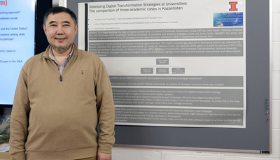 Mergen Dyussenov, one of the 2023-2024 Bolashak Scholars, poses for a photo next to his poster during the capstone event on May 9.