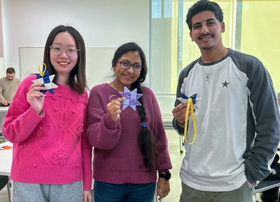 Three students hold up the ornaments they made during a Jan. 7 quilting workshop inside the Siebel Center for Design.