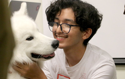 Photo of student petting Kirby