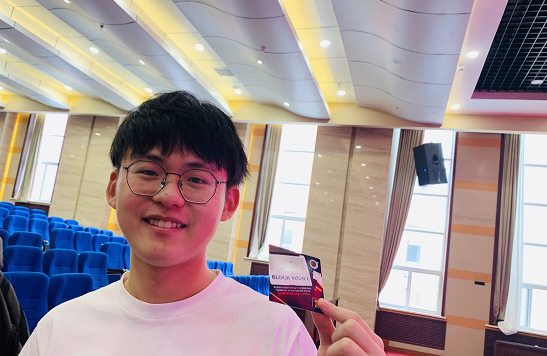 A student holds a card from an Academic Bridge program orientation