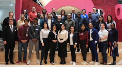 Illinois International senior leadership and Global Education and Training senior leadership pose for a photo with other staff and current Fulbright Fellows following a Feb. 6 welcome reception inside the Siebel Center for Design.