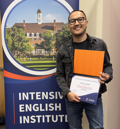 Nurken Aubakir posing with his IEI certificate.