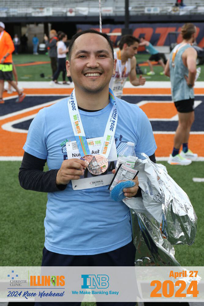 Nurken Aubakir poses with his medal following the Christie Clinic 10K race.
