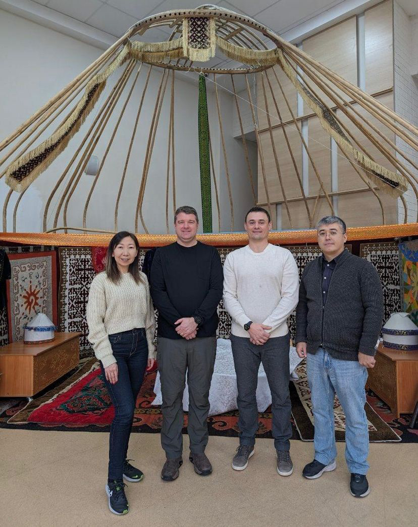 from left to right: Assel Aryn, Vice Rector for Academic Development at AlmaU; GET Director Matt Rosenstein; Grant Brewer,  GET Associate Director for Strategic Initiatives; and Kuanysh Abeshev, Dean of the School of Technologies at AlmaU pose for a photo during Rosenstein’s and Brewer’s visit to Kazakhstan in November 2023. Aryn and Abeshev were former Bolashak scholars at UIUC.