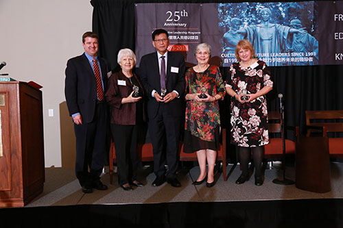Group photo of GET representatives and partners holding awards at an anniversary event