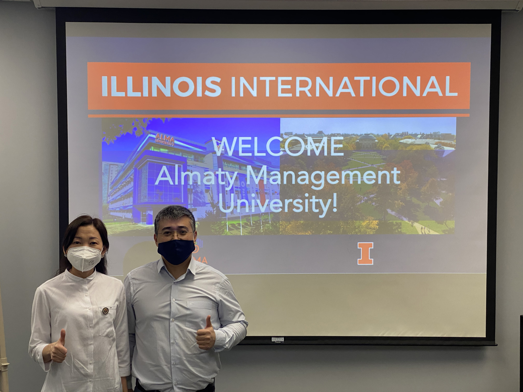 Aseel Aryn and Kaunysh Abeshev posing for a photo at an Illinois International Almanty Management Welcome conference
