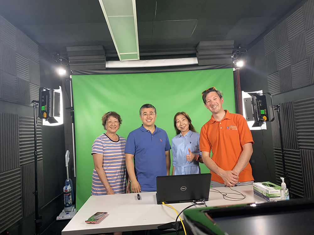 Aseel Aryn and Kaunysh Abeshev pose with faculty in green room