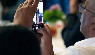 Andrew Kaniki, academic advisor to the FPP and Illinois alumnus, takes a photo during the program's closing reception inside the Illini Union on April 22.
