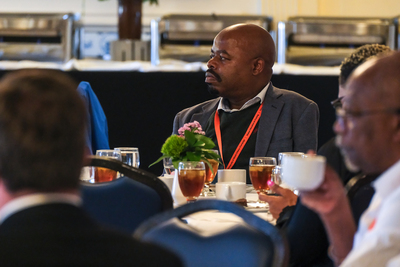 Mduduzi Biyase, professor in the School of Economics at UJ, listens to a speech during a closing reception inside the Illini Union on April 22.
