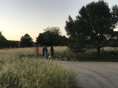 Monika Mendoza walking with her kids in a nice field