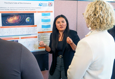Bolashak scholar Ulbossyn Ualikhanova, an instructor at Gumilyov Eurasian National University in Astana, Kazakhstan, explains her research to onlookers during the Bolashak 2025-2026 Research & Professional Development Showcase on May 8 inside the Illini Union.