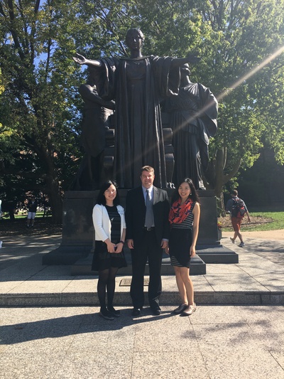 Photo of Karen Weng, Li Na, and Matthew Rosenstein in front of Alma Mater