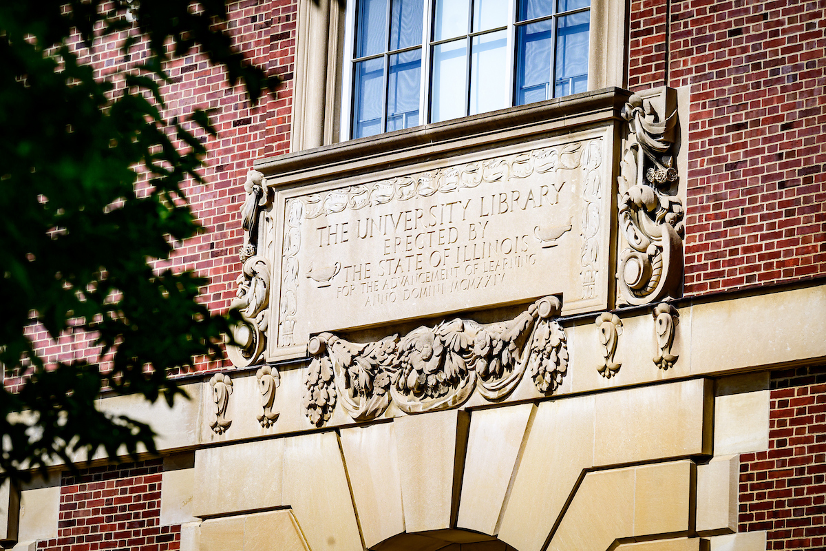 Tablet markers over the entrance of the Main Library, which is a historic library on the campus of the University of Illinois Urbana-Champaign. Built in 1924, the library was the third built for the school, replacing Altgeld Hall, which had become too small for the university's collections. Architect Charles A. Platt designed the Georgian Revival building, one of several on the campus which he designed in the style. The Main Library is part of the second largest university library collection in the United States. Photo taken at the University of Illinois Urbana-Champaign on Wednesday, June  25, 2025.  (Photo by Fred Zwicky / University of Illinois Urbana-Champaign)