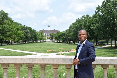 Mayamiko Nyankalwa poses in front of Foellinger Hall
