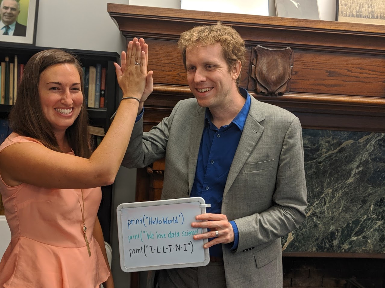 Wade Fagen-Ulmschneider and Karle Flanagan stand with a student holding a certificate at Illinois