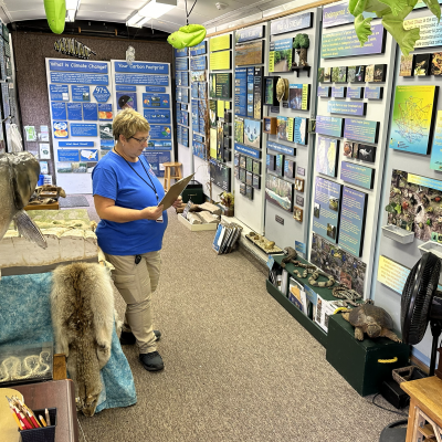 A woman standing inside the Traveling Science Center.