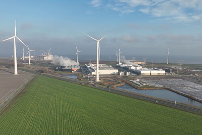 Data center surrounded by fields and wind mills