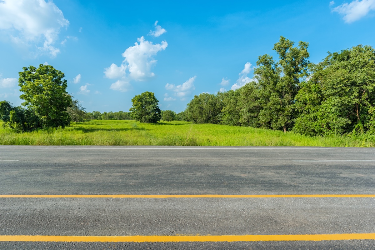 Highway in the foreground and natural landscape in the background