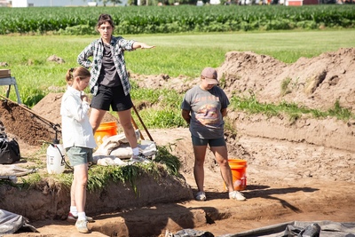 Sarah Baires directs colleagues at an archaeological dig