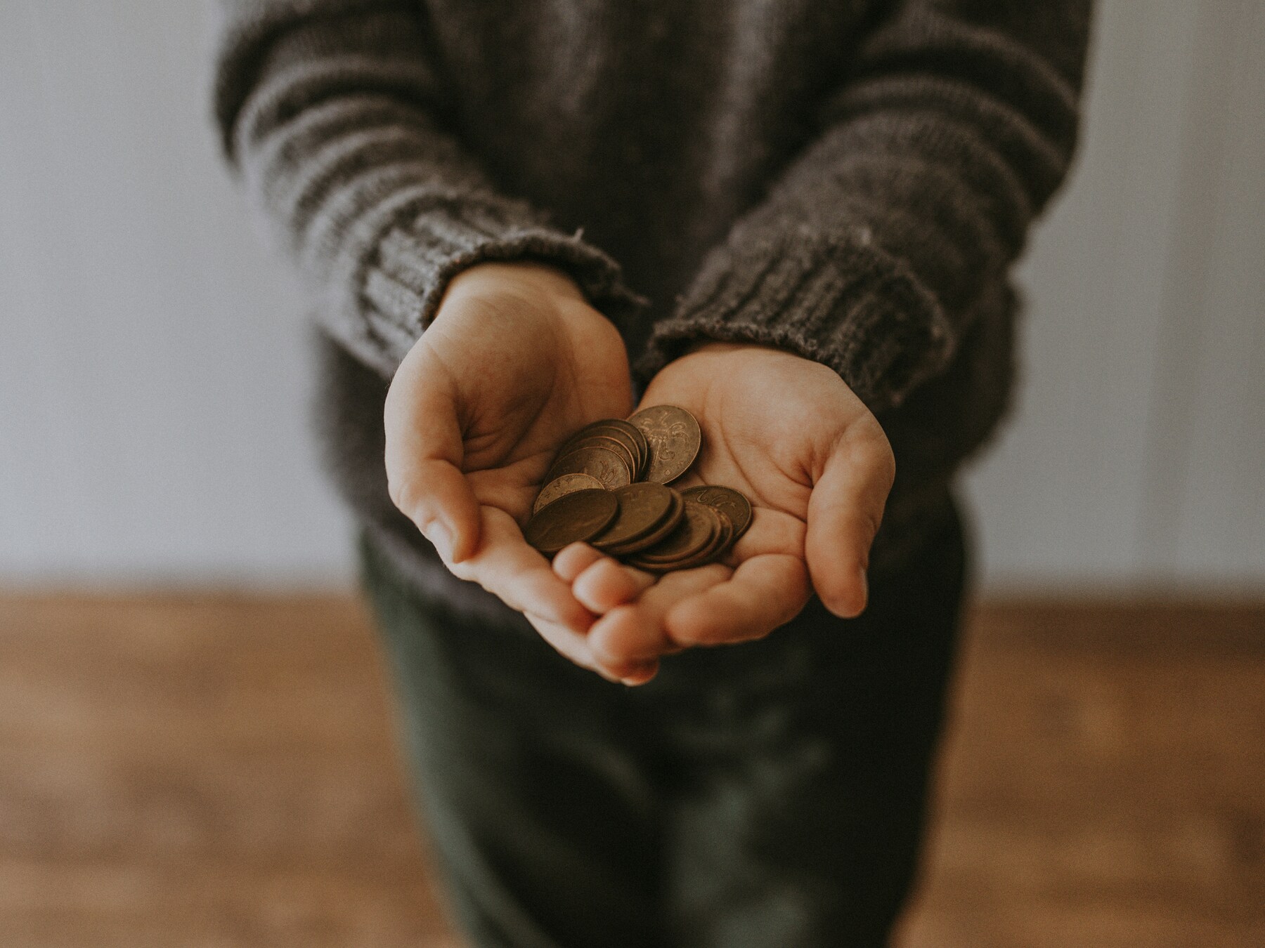 Copper-colored coins in a person's hands