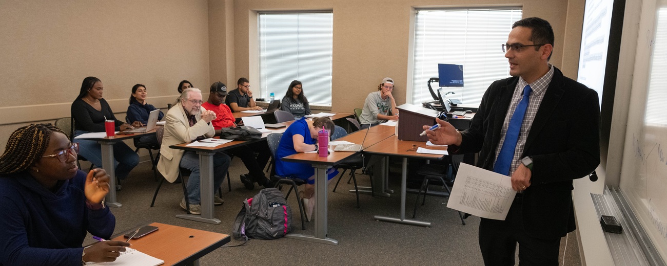 Professor teaching adult learners in classroom