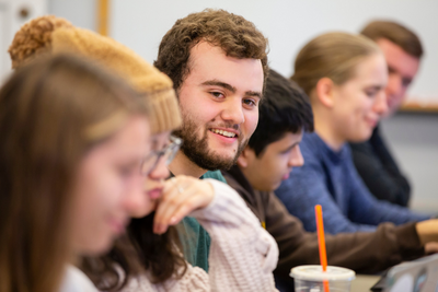 a row of students smiles during a class