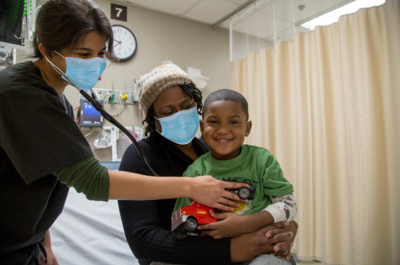 a boy receiving care in a hospital room