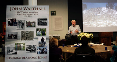 Walthall in front of screen, presenting to people at tables.