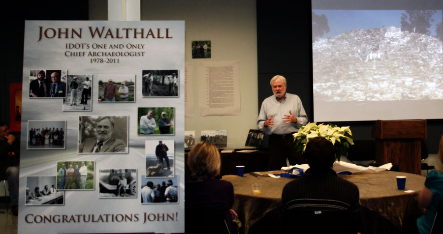 Walthall in front of screen, presenting to people at tables.