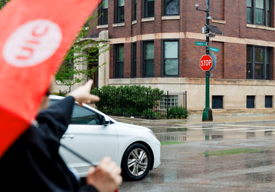 UIC's Serap Erdal pointing at the air quality sensor on the north side of Chicago.