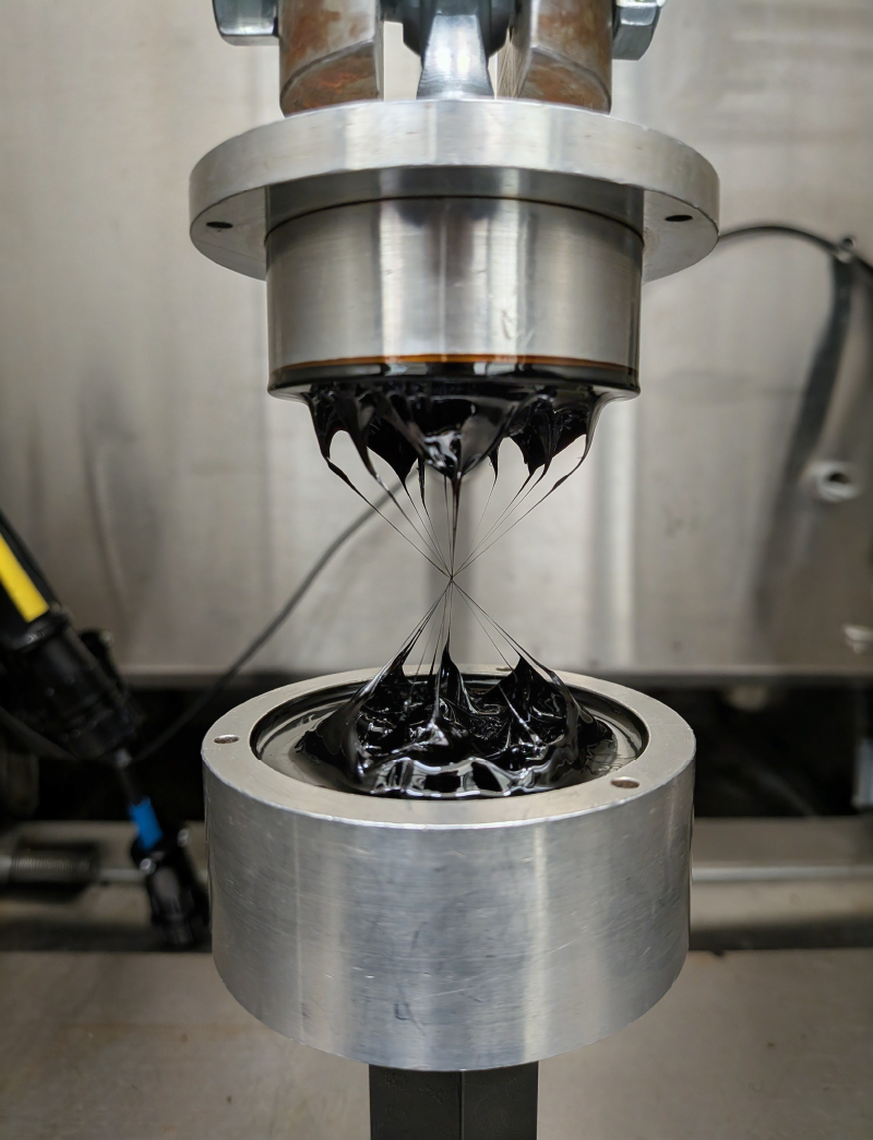 Filaments of Failure. Asphalt binder under the poker chip test.